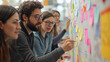 © Frank Gärtner - Young entrepreneurs collaborate and generate new concepts using colorful sticky notes on a whiteboard during a brainstorming session