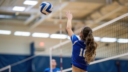 A girl is playing volleyball and is about to hit the ball