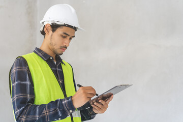 Building inspection asian contractor young man, male inspecting home, reconstructed construction, renovation or check defect, before finish handing it over to client, customer. Engineering worker.