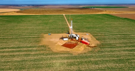 Wall Mural - Distancing from a natural resources industry company in the middle of the desert. Aerial perspective on the oil production site in the vast field.