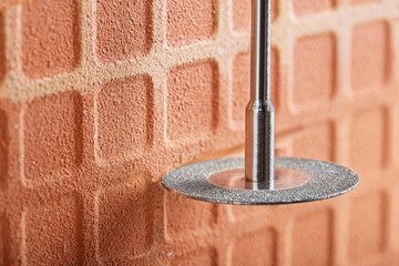 Wall Mural - Diamond coated disc cutting brick or making grooves in concrete wall. Industry and construction.