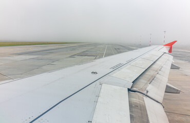 Wall Mural - View from the airplane window during taking off on a clear summer morning. Yekaterinburg, Russia