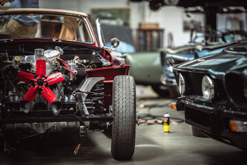 Classic cars being restored in a vintage vehicle garage workshop