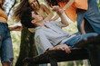 © qunica.com - Group of young friends having fun and enjoying each other's company in a sunny park. Happy moments and outdoor activities.