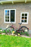 Old bicycle next to canal of Amsterdam