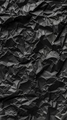 Aufkleber - The texture of crumpled black paper reveals a complex interplay of shadows and highlights, emphasizing its unique surface details