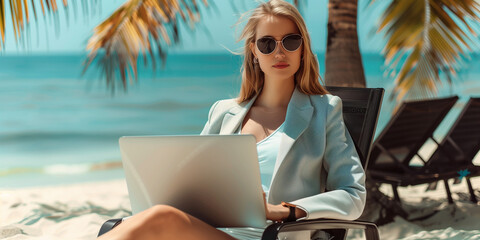 Wall Mural - digital nomad working on a laptop from a beach lounge chair, woman working remotely from a tropical beach setting. She is sitting at a wooden table with a laptop in front of her, smiling as she types