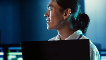 Poster - close up shot of happy employee wandering around data center infrastructure providing processing res