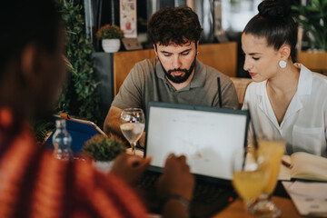 Poster - Diverse group of people collaborating in a coffee bar meeting, focusing on business strategies and ideas with laptops and drinks.