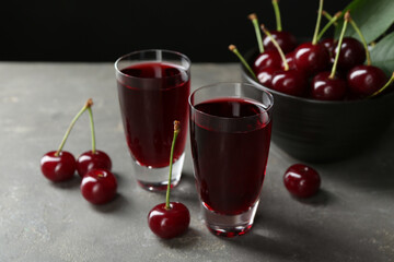 Sticker - Delicious cherry liqueur in shot glasses and fresh berries on grey table