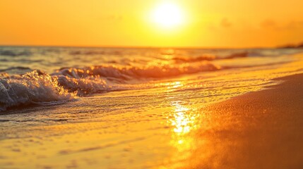 Beautiful beach view with orange and golden sky at summer sunset.