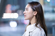 © amanaimages - 夜の雑踏にいる女性の横顔