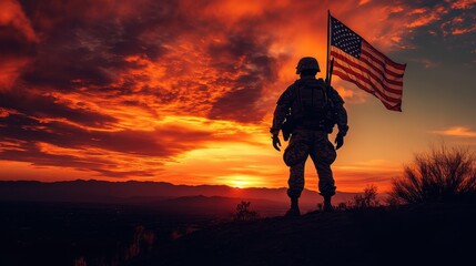 Silhouetted Soldier with American Flag at Sunset Over Mountains.