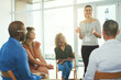 © TamJam/peopleimages.com - Meeting, office and woman with business people in circle for support, staff counselling and teamwork. Creative company, collaboration and workers in discussion for planning, feedback and cooperation
