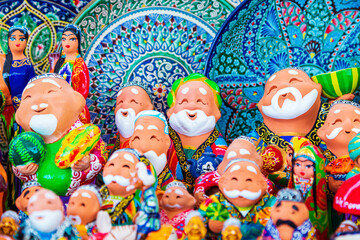 Wall Mural - Funny souvenirs - figures of people at the Siab market.