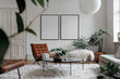 © Roman - Frame mockups on a white wall in scandinavian style living room, brown leather armchair, potted plants. Two blank vertical din A posters with black frames in light room interior design