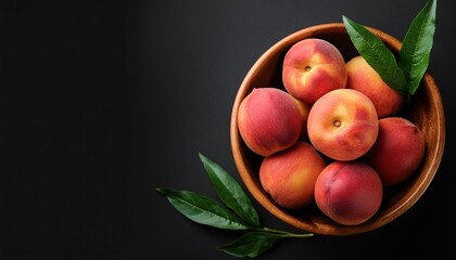 Wall Mural - peach in a bowl on a black background, top view, copy space