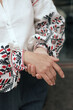 © Forewer - Close-up of female hands in shirt with red and black thread, space for text. Ukrainian national clothes. Part of the series.