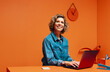 © Jacob Lund - Female manager typing on laptop in monochromatic office space
