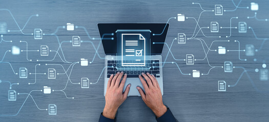 Poster - Businessman hands typing on laptop, document management system hologram