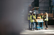 © Jacob Lund - Group of happy warehouse employees having a meeting together
