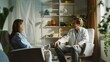 © robfolio - Therapist Consulting with Patient in Cozy Office Setting
