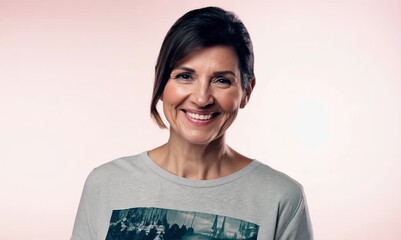 Sticker - Portrait of a beautiful middle aged woman smiling against a pink background