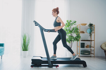 Poster - Photo of active energetic healthy woman wearing activewear running treadmill physical exercises home gym indoors