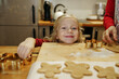 © Westend61 - Smiling girl leaning on cutting board in kitchen at home