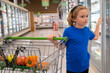 © Volodymyr - Kid with shopping cart at grocery store. Portrait of child in a food store or a supermarket. Little kid going shopping. Healthy food for kids.