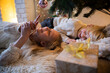 © Westend61 - Happy girl and boy lying down under Christmas tree at home