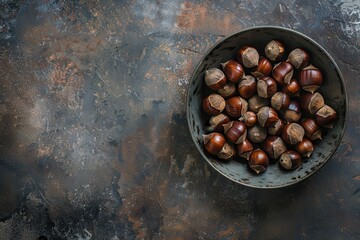 Poster - Chestnuts in bowl on dark background top view with space for text