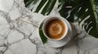 © Rizwan - Gorgeous tropical foliage arranged tastefully to the side of an attractive top view of a hot coffee cup on a flat lay marble background combine to create a calm and fashionable composition.
