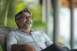 © Kevin - Handsome indian asian mid age man sitting on chair and relaxing, Generative AI