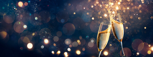 Wall Mural - happy new year - champagne toast celebration - goblets with golden glittering on blue abstract backg