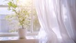 © savittree - Soft white curtains fluttering in the breeze by an open window, creating a serene and peaceful atmosphere.
