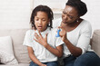 © Prostock-studio - African Girl Having Asthma Attack, Worried Mom Giving Her Inhaler For Relief. Copy space