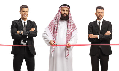 Wall Mural - Saudi arab man with bodyguards cutting a red ribbon