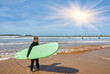 © Ryzhkov Oleksandr - A young surfer strikes a pose with his board on the oceanfront in Essaouira