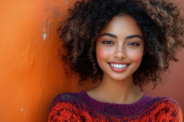 Canvas Print - Bright and Cheerful Close-Up of a Young Woman with Curly Hair in Red and Purple Sweater