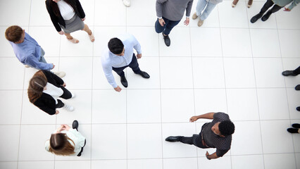 Group of company workers walking in office corridor