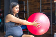 © puhimec - Pregnant sports woman with fit ball in the gym. The concept of sports lifestyle.