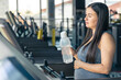 © puhimec - Pregnant woman on a treadmill in the gym. Healthy sports lifestyle.