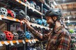 © Werckmeister - Smiling guy deciding on new helmet in sports equipment store
