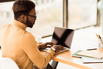 Aufkleber - Checking E-mail. Afro businessman learning, working on laptop, using applications on netbook, copyspace