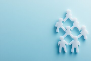 White Paper Cutout People Forming a Circle on a Light Blue Background