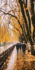 Wall Mural - Autumn Walk Along a Canal With Yellow Leaves and People