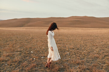 Poster - Tranquil sunset beauty in white dress standing alone in open field at dusk