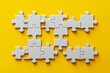 © olvius - White puzzles on yellow background, space for text