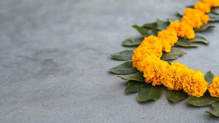 Wall Mural - A long yellow flower arrangement with green leaves is on a grey surface